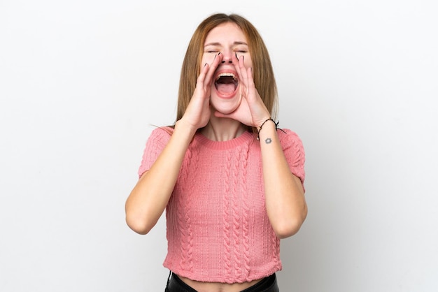 Photo young english woman isolated on white background shouting and announcing something