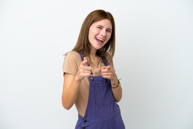 Young English woman isolated on white background surprised and pointing front