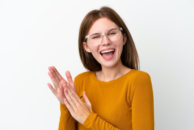 Young English woman isolated on white background With glasses and applauding