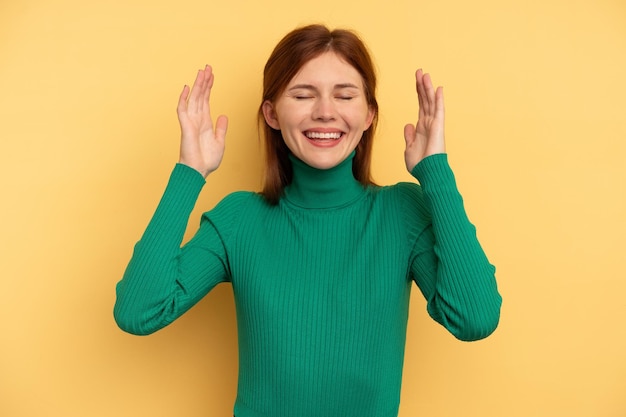 Photo young english woman isolated on yellow background joyful laughing a lot. happiness concept.