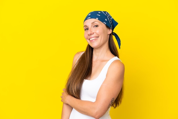 Young English woman isolated on yellow background laughing