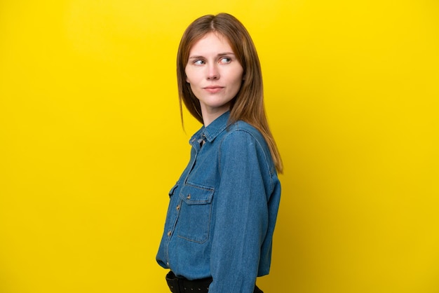Young English woman isolated on yellow background Portrait
