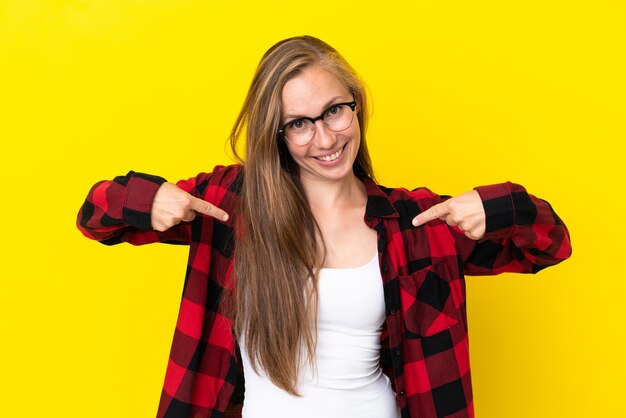 Young English woman isolated on yellow background proud and self-satisfied