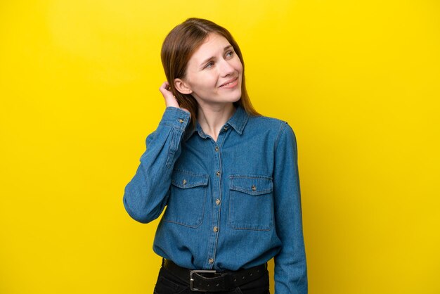 Young English woman isolated on yellow background thinking an idea