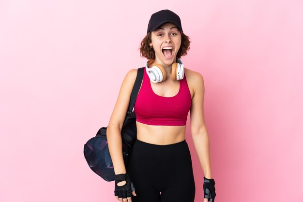 Young English woman on pink with surprise facial expression