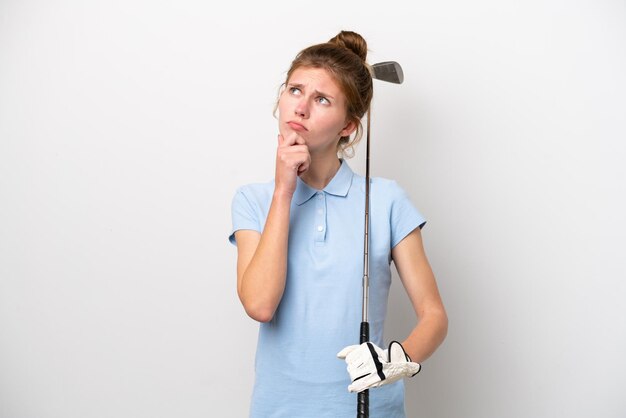 Young English woman playing golf isolated on white background having doubts