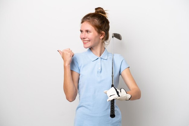 Young English woman playing golf isolated on white background pointing to the side to present a product