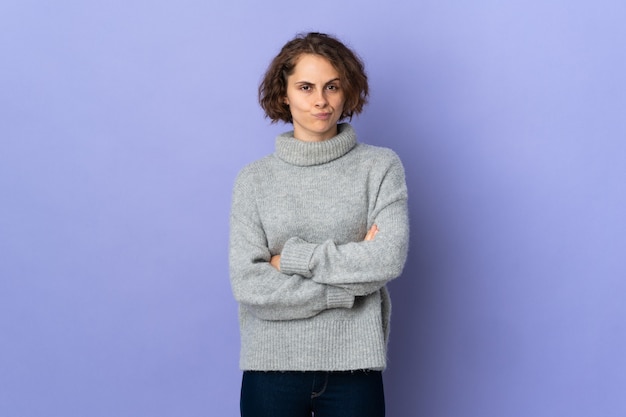 Young English woman on purple background feeling upset