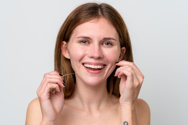 Young English woman using dental floss with happy expression Close up portrait