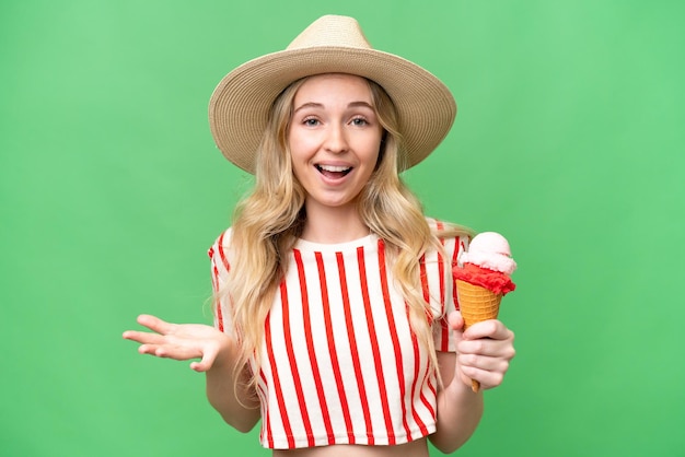 Young English woman with a cornet ice cream over isolated background with shocked facial expression