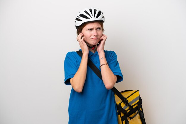 Young English woman with thermal backpack isolated on white background frustrated and covering ears