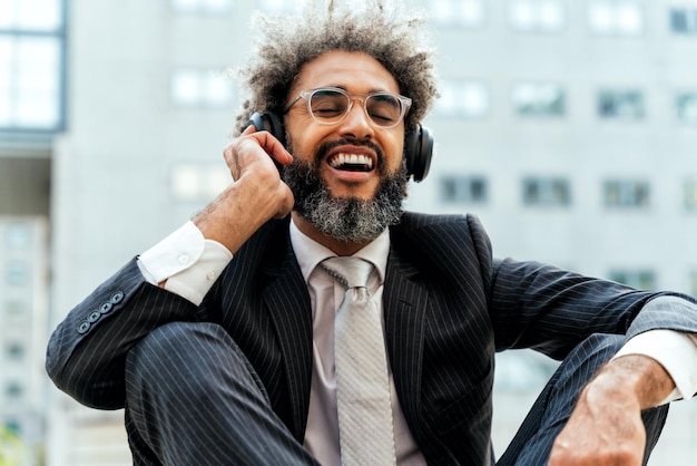 Young entrepreneur business man listening to music and dance