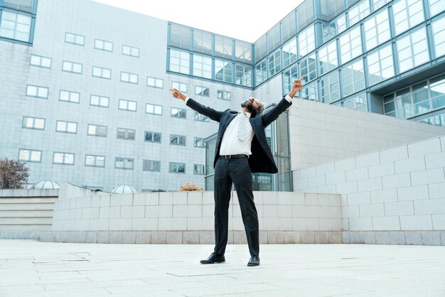 Young entrepreneur business man listening to music and dance