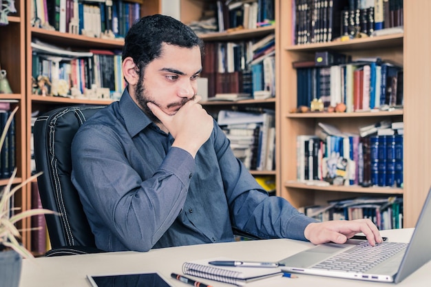 Young entrepreneur freelance working on a desk with a laptop at home