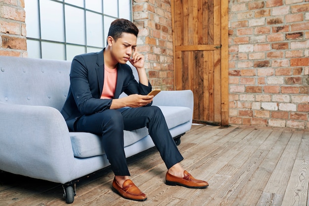 Young entrepreneur reading bad news