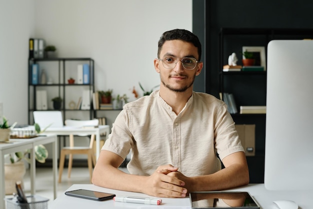 Young entrepreneur sitting by workplace