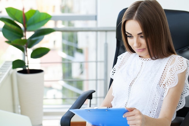 Young entrepreneur woman working with laptop sitting in the office