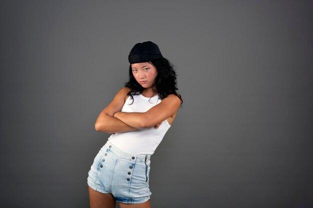 Young ethnic asian woman in urban attire defiant attitude