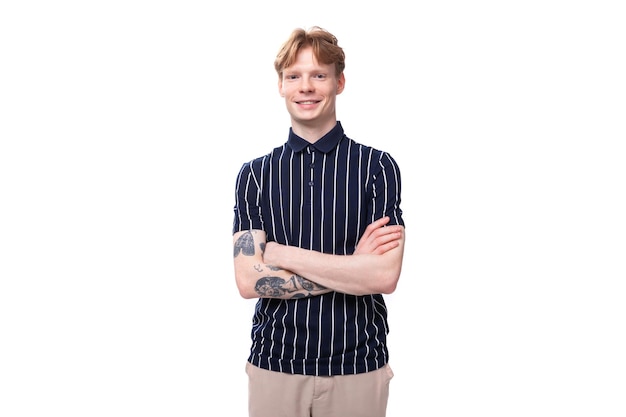 Young european blond guy in a striped polo shirt on a white background