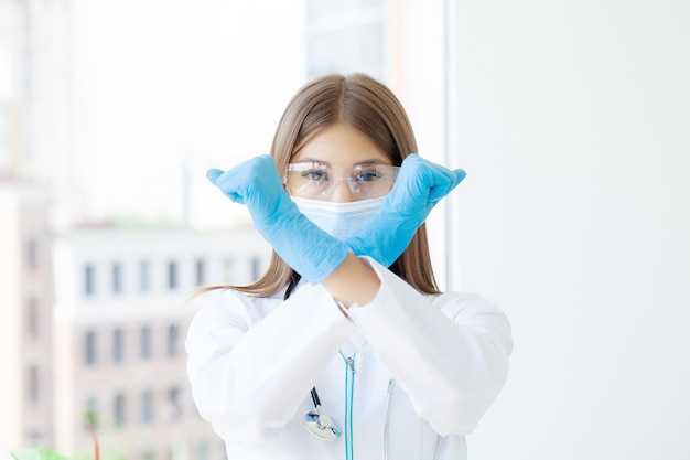 Young european doctor woman crossing arms doing negative sign