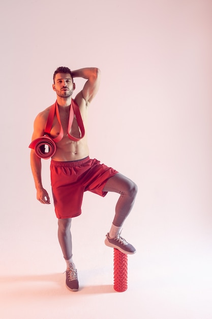 Young european sports man with sports equipment