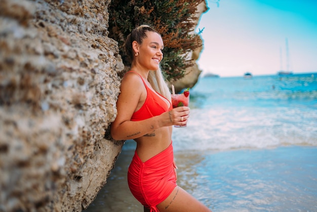 Young European woman in bikini on the beach in summer Tanned blonde girl