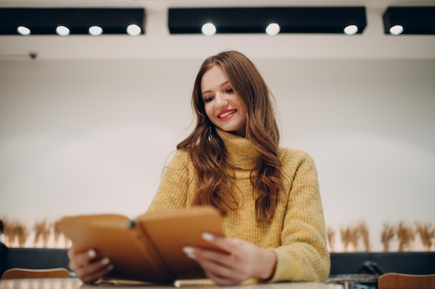 Young european woman read book in cafe