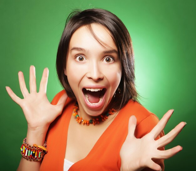 Young expression woman over green background