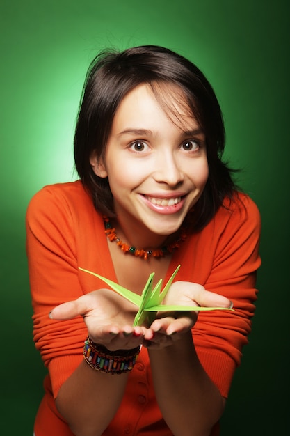 Young expression woman with paper bird