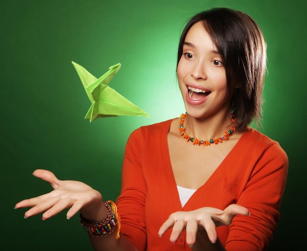 Young expression woman with paper bird