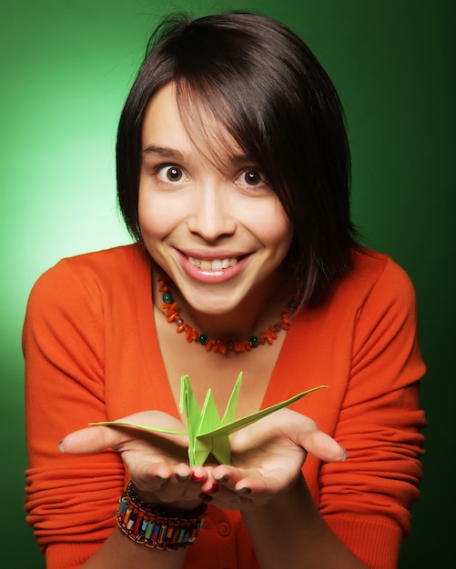 Young expression woman with paper bird