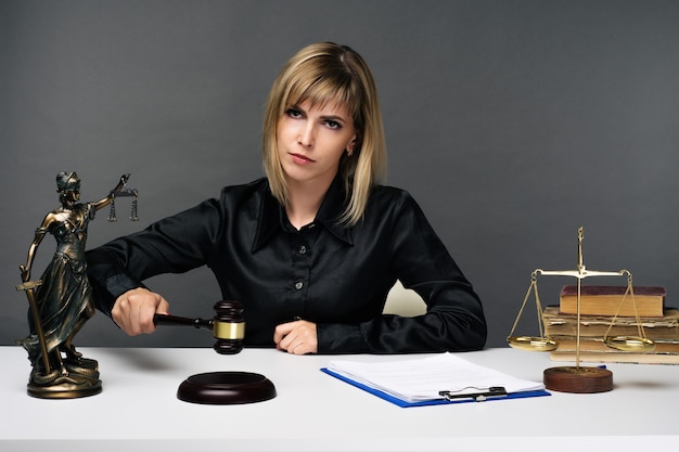 A young fair woman judge works in her office. - image