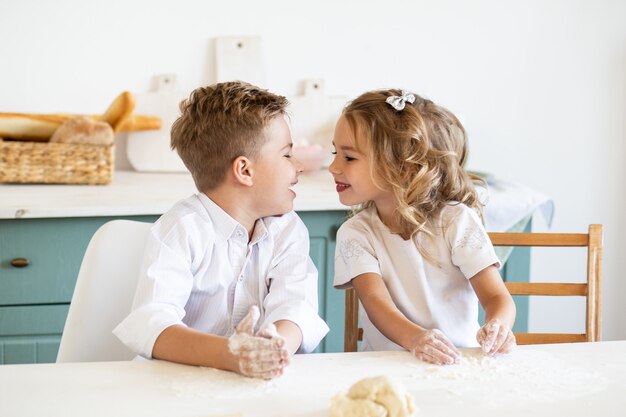 Young family cooking cookies together in kitchen