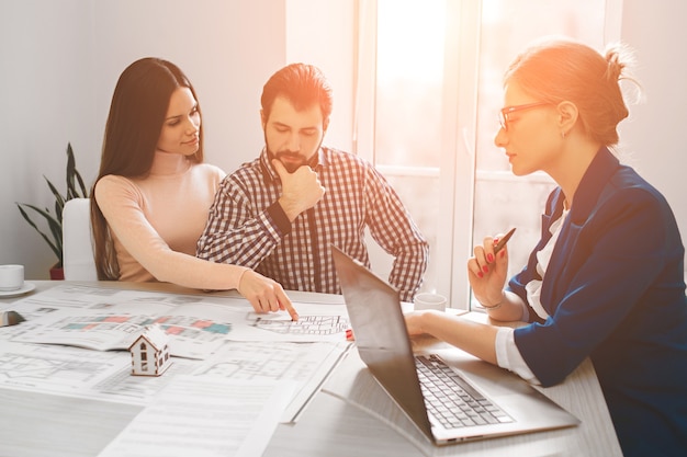 Young family couple purchase rent property real estate. Agent giving consultation to man and woman