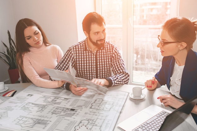 Young family couple purchase rent property real estate. Agent giving consultation to man and woman