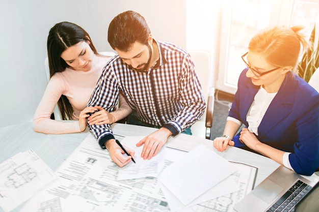 Young family couple purchase rent property real estate. Agent giving consultation to man and woman