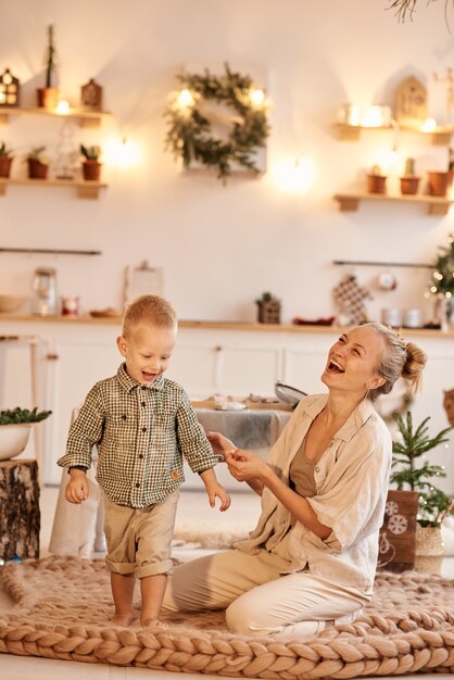 Young family dad, mom and their little son have a fun playing and cooking in the kitchen