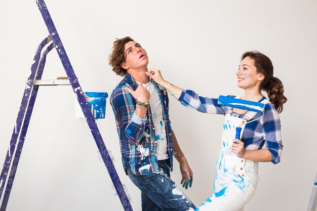 young family doing redecoration and painting walls