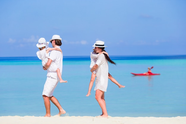 Young family of four on beach vacation