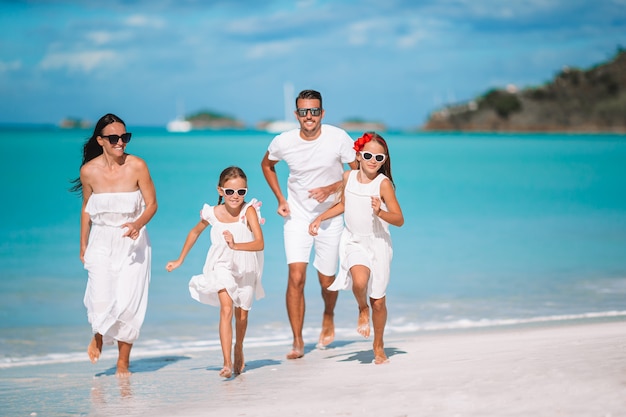 Young family of four on vacation have fun