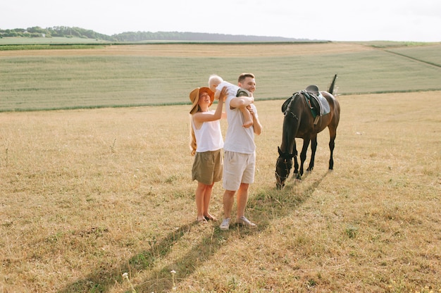 A young family have a fun in the field