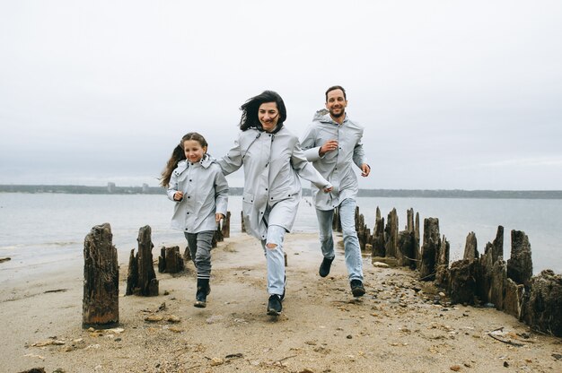 a young family have a fun near the sea on a boat background