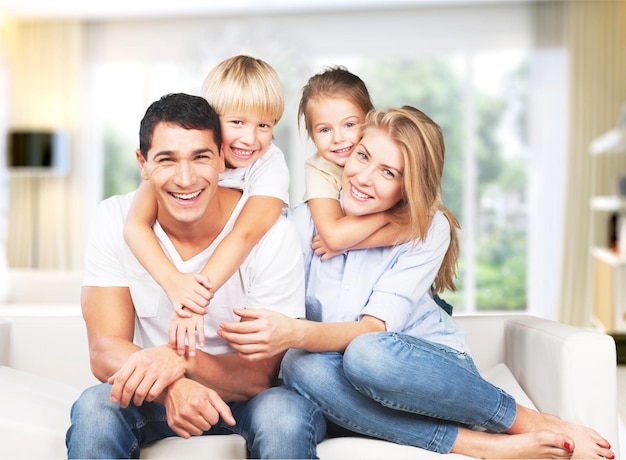 Young  family at home smiling at camera