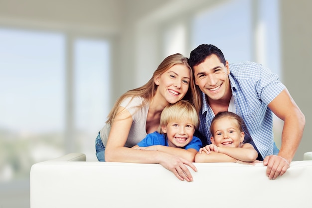 Young  family at home smiling at camera