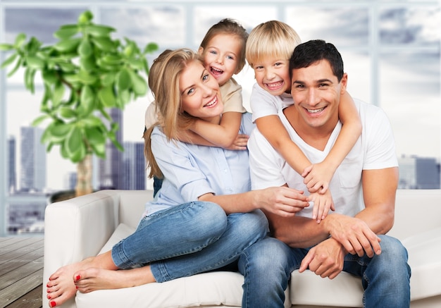 Young  family at home smiling at camera