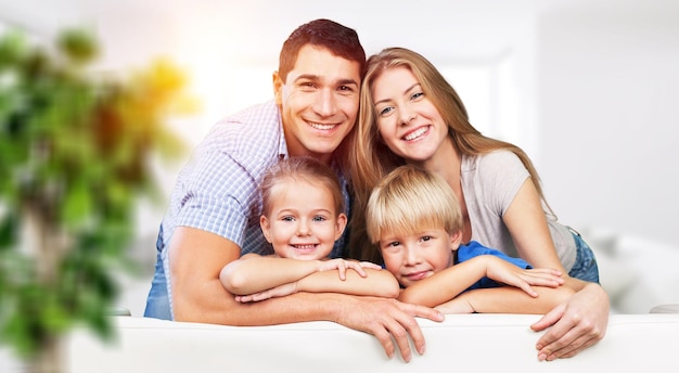 Young family at home smiling at camera