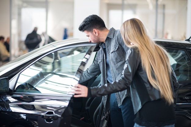 Young family looking for their car purchase together