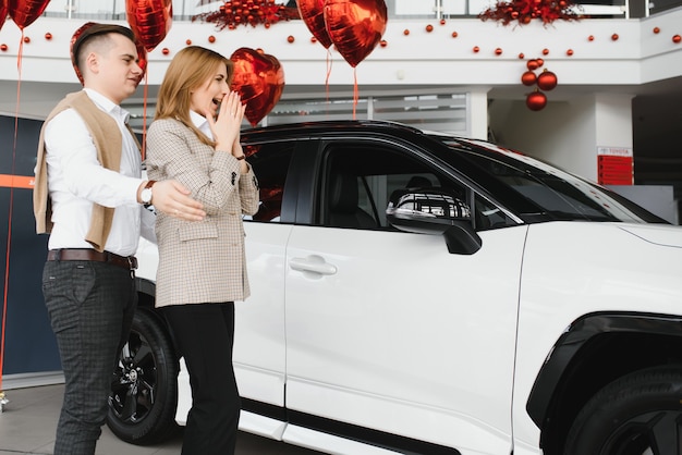 Young family making selfie in a car show room