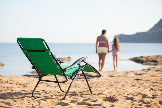 Young family, mom with a child have a rest on the ocean.