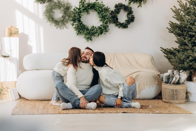 Young family near Christmas tree at home